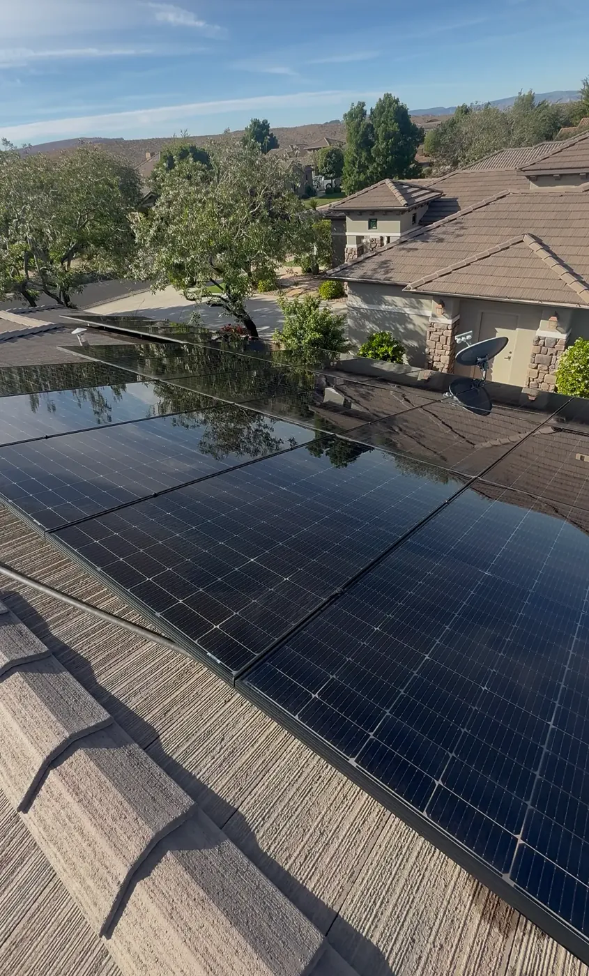 Freshly cleaned rooftop solar panels on a tile roof